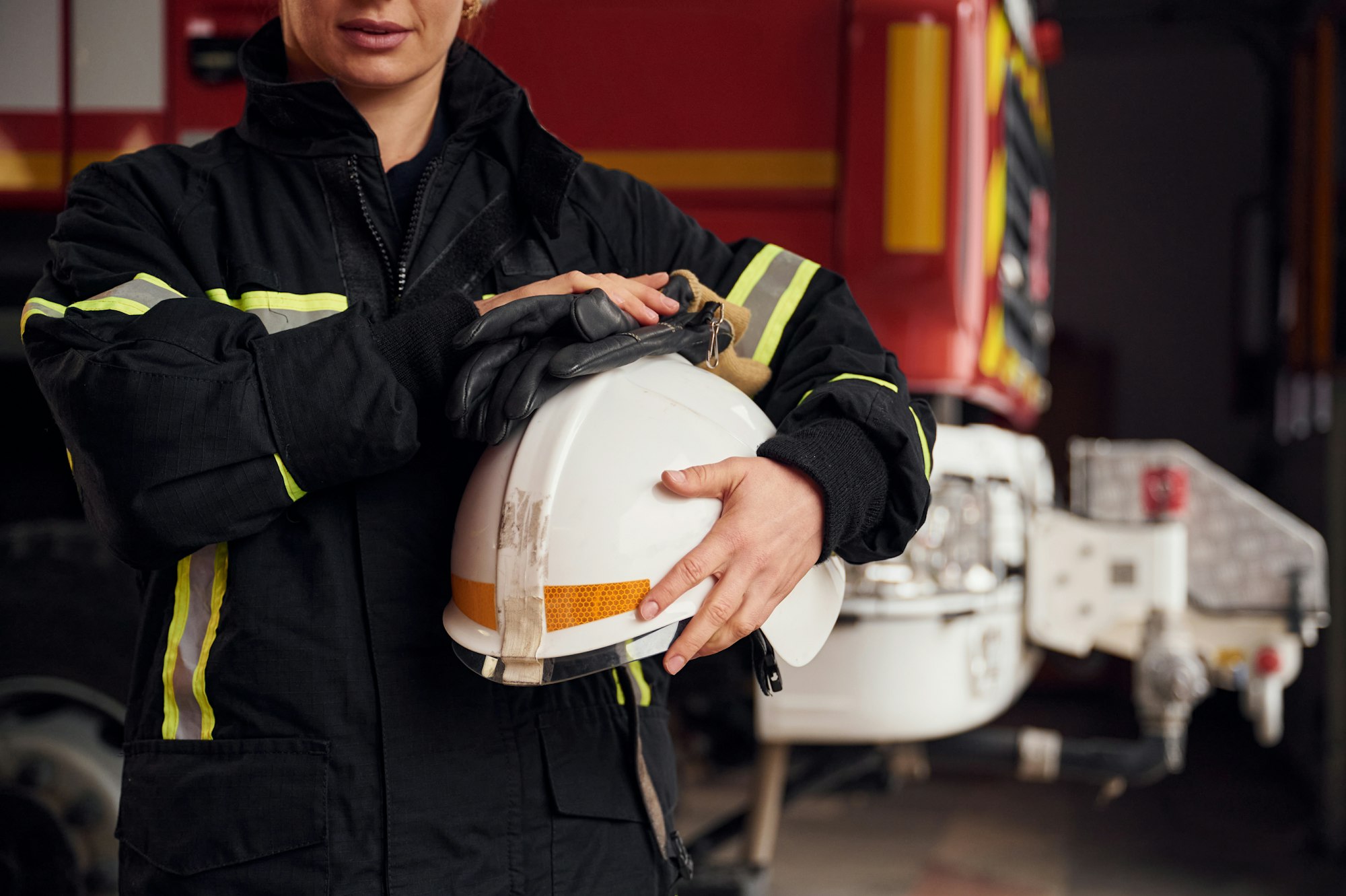 Woman firefighter in uniform is at work in department
